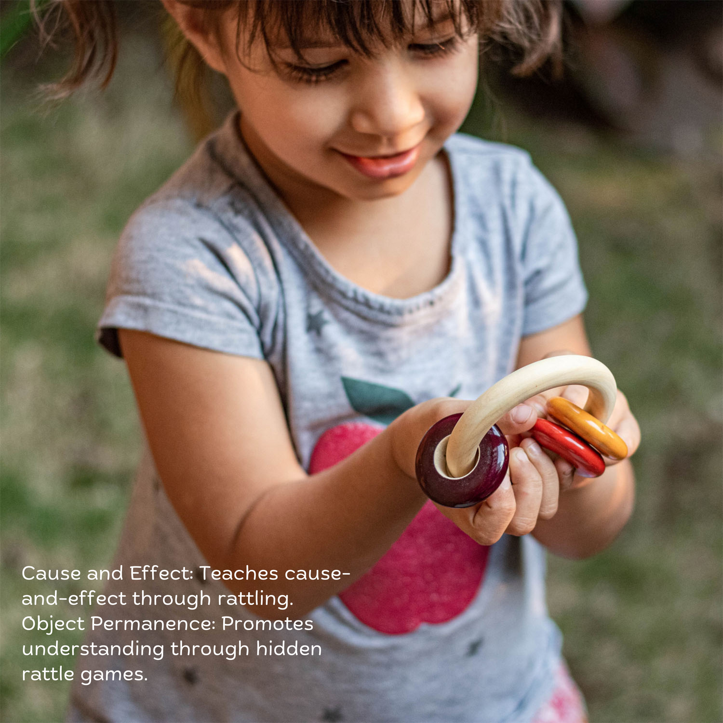 Wooden Tiny Tot Treasure Bundle The Toy Trunk – baby girl playing with Ringo rattle to develop sensory and motor skills