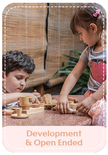 Two children playing together with wooden toys in a warm, natural setting, illustrating open-ended, age-appropriate play.