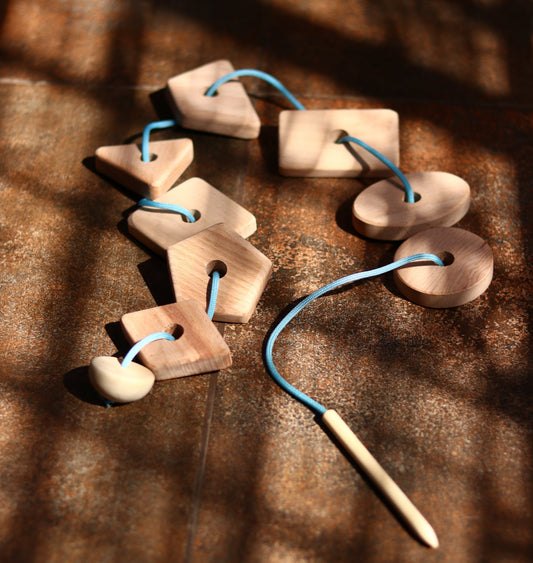 How Lacing and Threading Toys Build Fine Motor Skills, Pencil Grip and Pre-Writing Readiness in Children