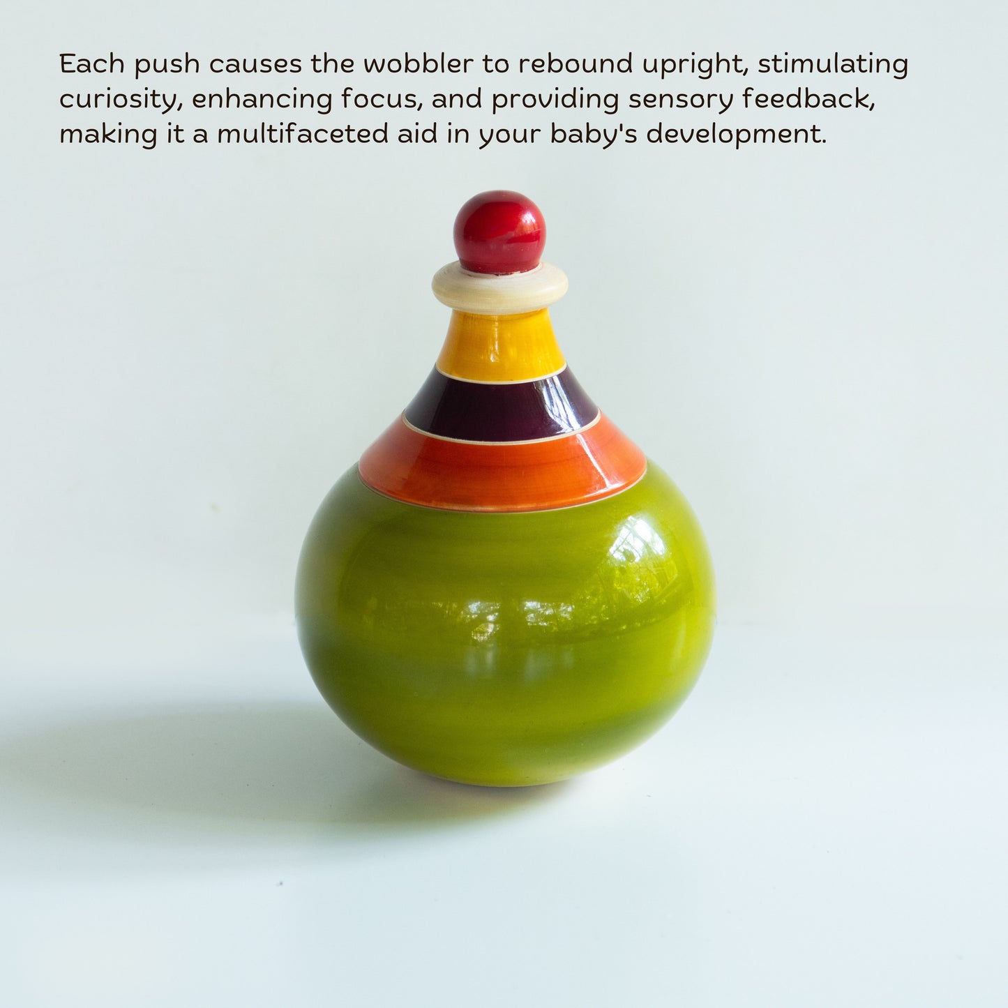 Handcrafted Wooden Globe Wobbler with rounded shape for baby sensory play and visual tracking.