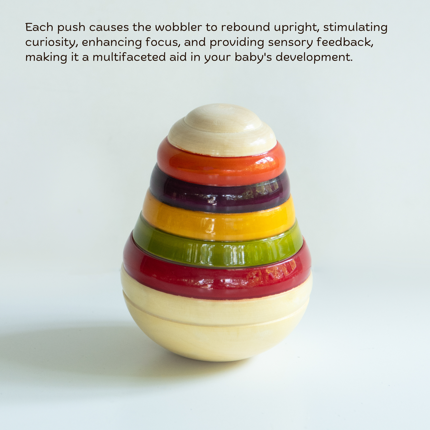 Wooden Pear Wobbler showing rounded shape for balance, tummy time and visual tracking.