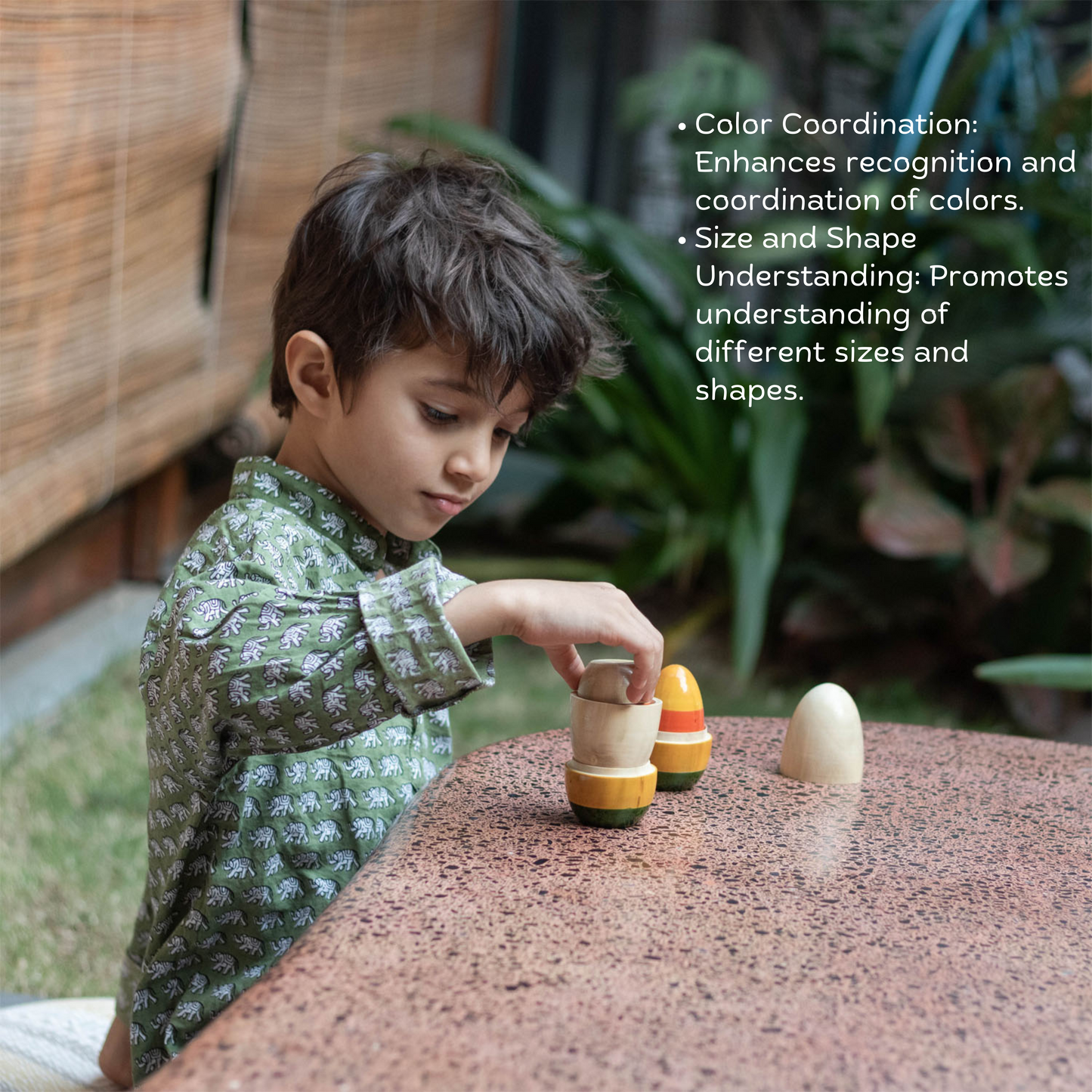 Baby boy playing with Wooden Nesting Eggs from The Toy Trunk – Montessori-inspired handmade wooden toy for sensory exploration & fine motor skills