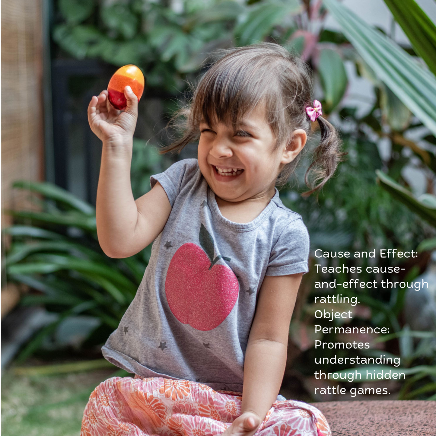 Baby Girl playing with wooden egg rattle from The Toy Trunk Wooden Playful Trio – handmade wooden toy for sensory play & fine motor skills with benefits