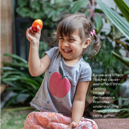Baby Girl playing with wooden egg rattle from The Toy Trunk Wooden Playful Trio – handmade wooden toy for sensory play & fine motor skills with benefits