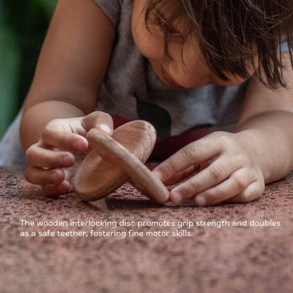 Close-up of wooden interlocking disc for baby hand exploration.
