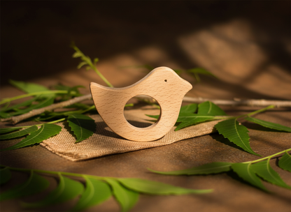 Close-up of neem wood bird teether for babies 0–12 months.