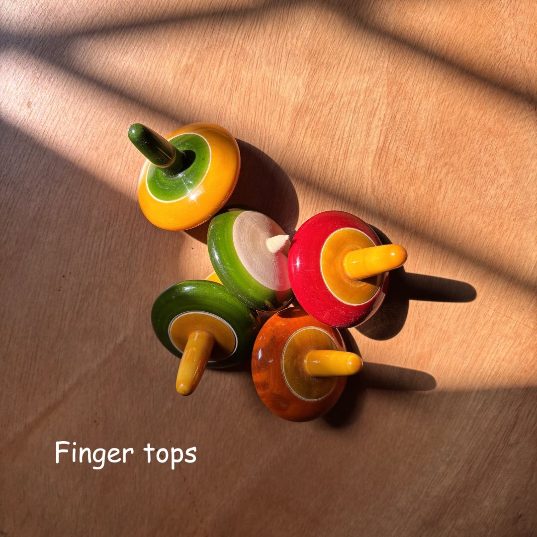 Colourful wooden finger spinning tops, also known as traditional lattu toys.