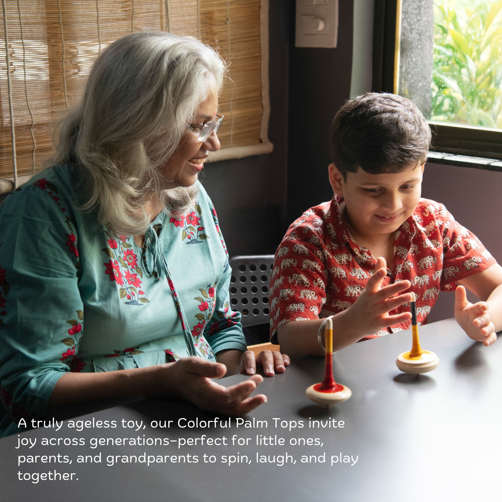 Grandmother and child playing with traditional wooden spinning tops.