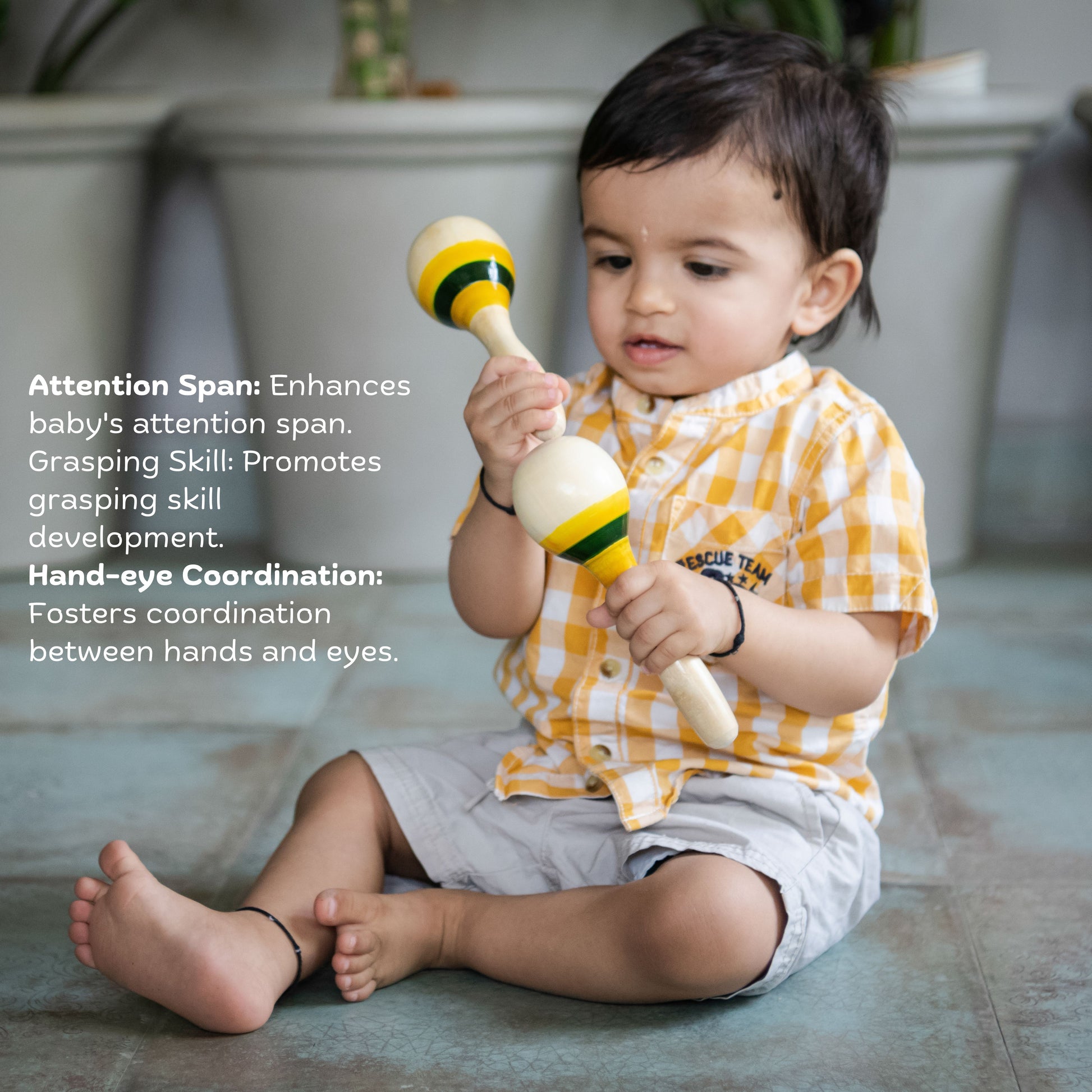 Toddler playing with Wooden Maraca Rattle (Set of 2) – bright, safe, eco-friendly handmade wooden toy promoting sensory development & hand-eye coordination
