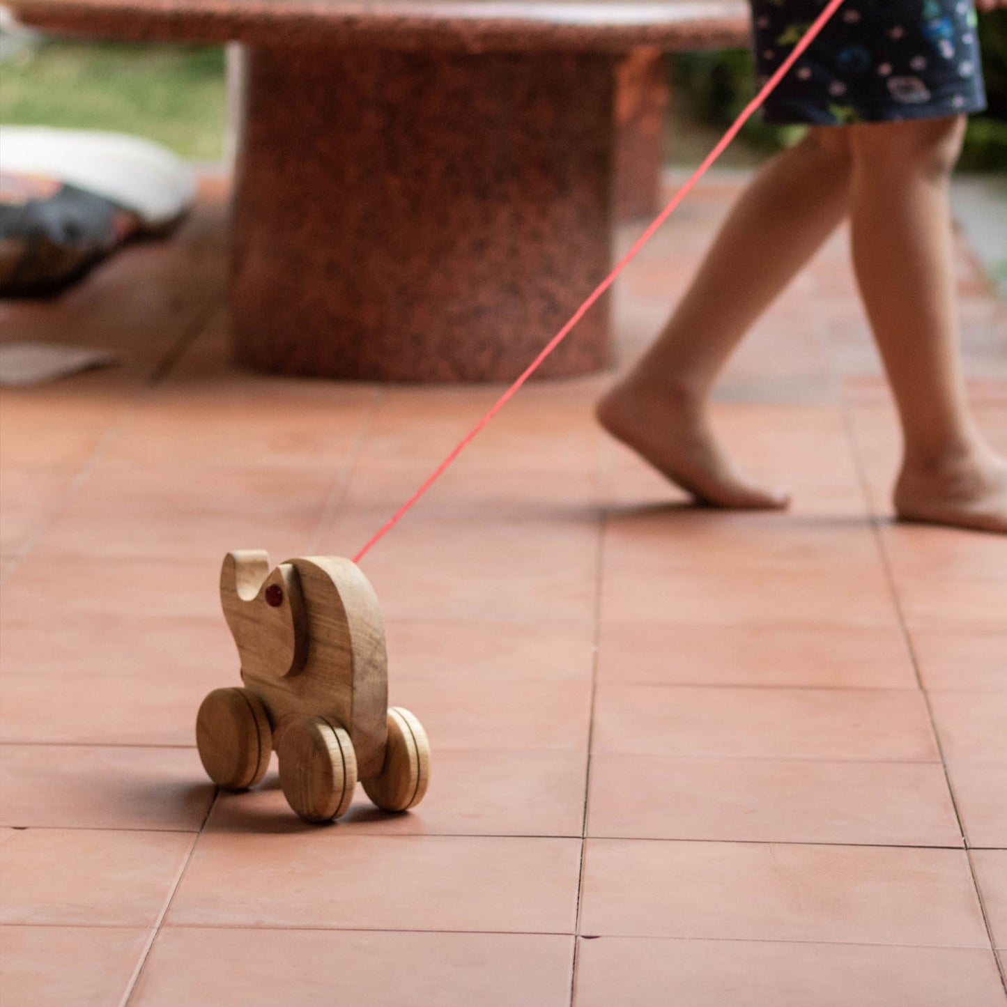 Kid playing with Wooden Ellie the Elephant – Montessori-inspired pulling & lacing toy for toddlers, enhancing problem-solving, sensory & motor skills