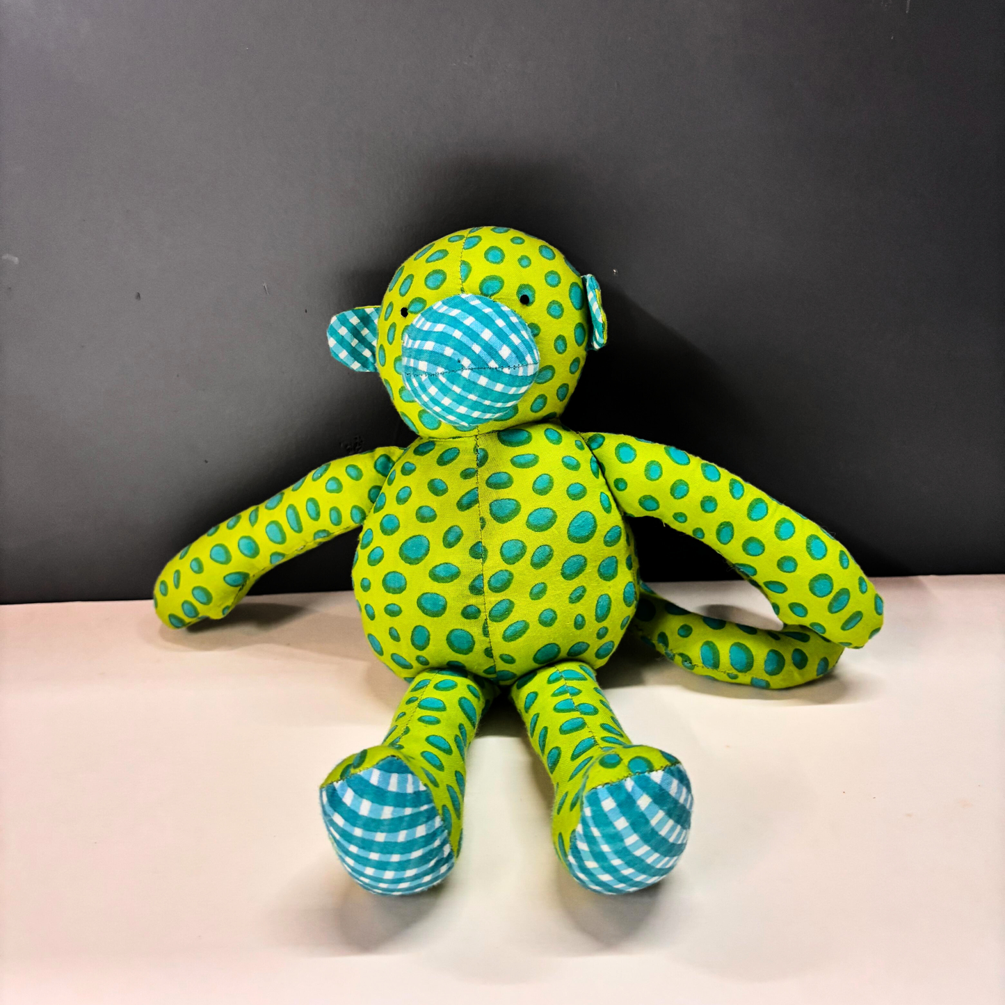 Mimi Monkey handmade cotton soft toy in lime and teal spotted handblock print.