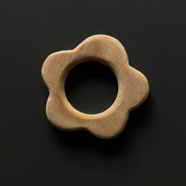 Neem wood flower teether from Tiny Tot Baby Activity Box for teething relief.