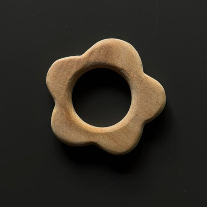 Neem wood flower teether from Tiny Tot Baby Activity Box for teething relief.