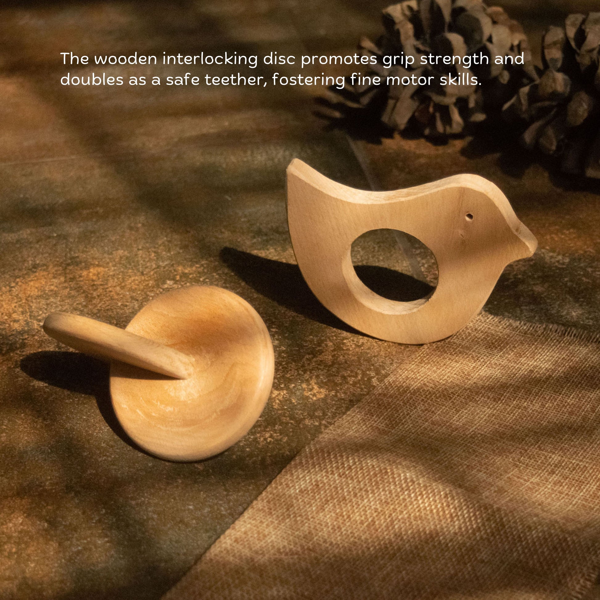 Wooden bird teether and interlocking disc for grasping and motor skill development.