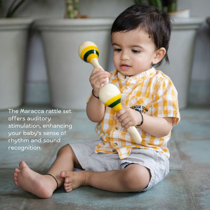 Baby playing with wooden maraca rattle for sound play and sensory development.