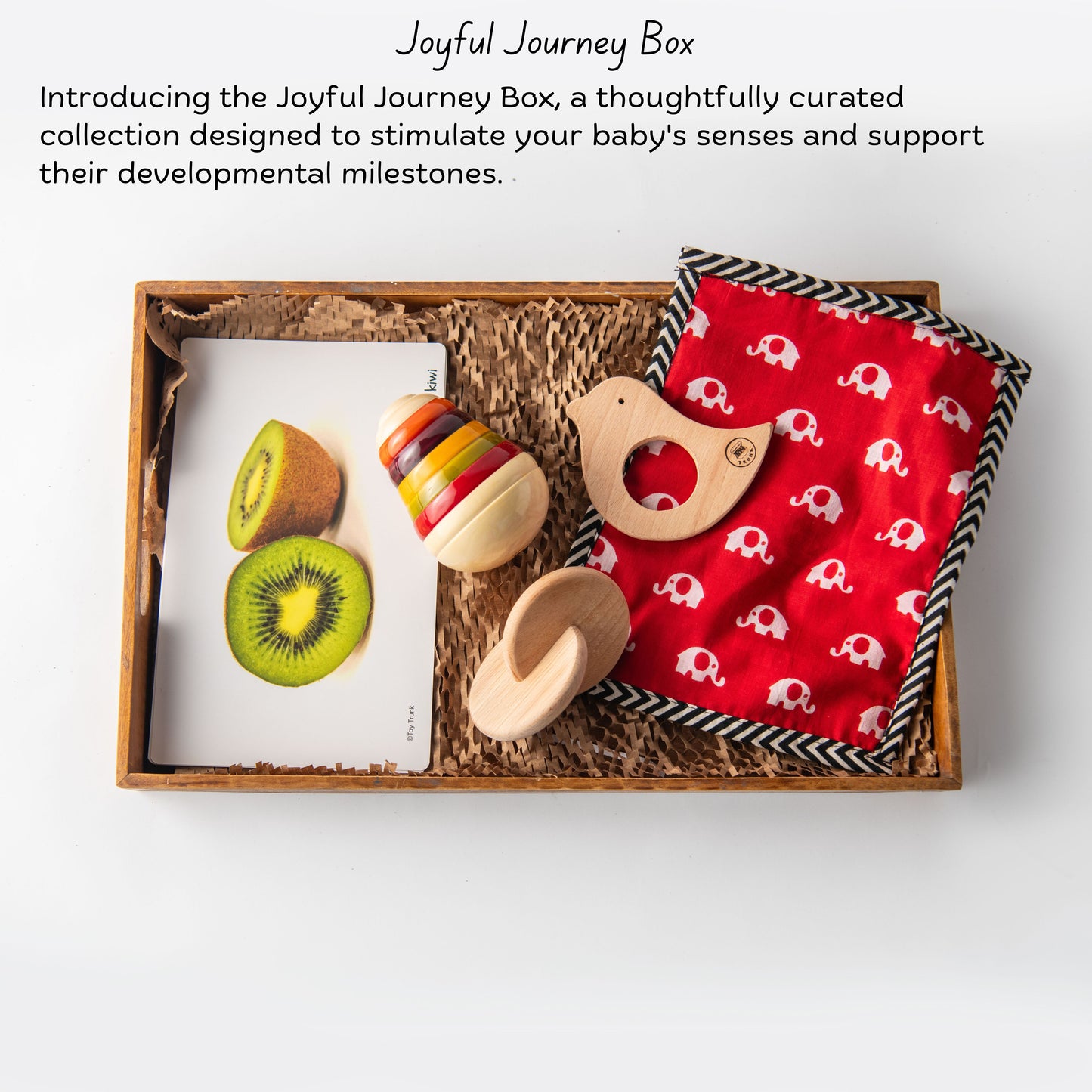 The Toy Trunk Wooden Joyful Journey Box with pear wobbler, bird teether, interlocking disc, herb bag, and fruit flash cards