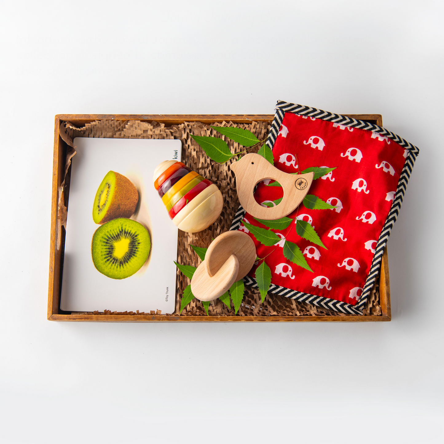 Wooden Joyful Journey Baby Box with pear wobbler, bird teether, interlocking disc and fruit flash cards.
