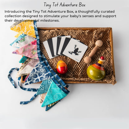 The Toy Trunk Wooden Tiny Tot Adventure Box with dumbbell teether, egg rattle, globe wobbler, flash cards and zero waste bunting