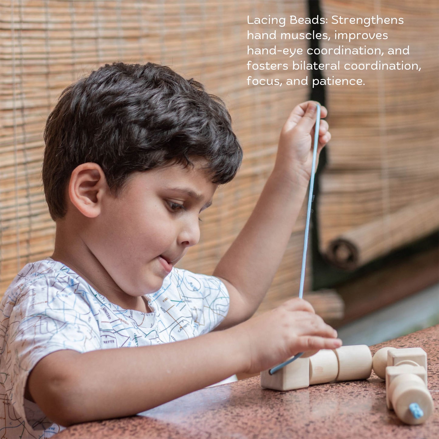 Wooden Giant Montessori Box The Toy Trunk – child lacing beads to develop focus, grip, and hand-eye coordination