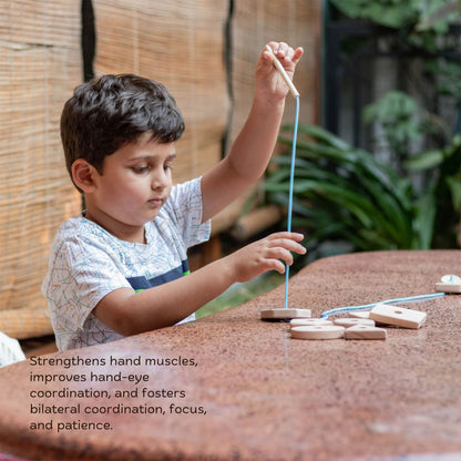 Wooden Giant Montessori Box The Toy Trunk – child threading geometric shapes with wooden needle to improve fine motor skills