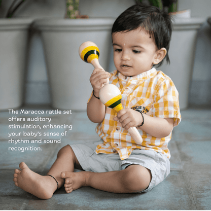 Baby playing with wooden maraca rattle from Jolly Jingle Baby Gift Box.