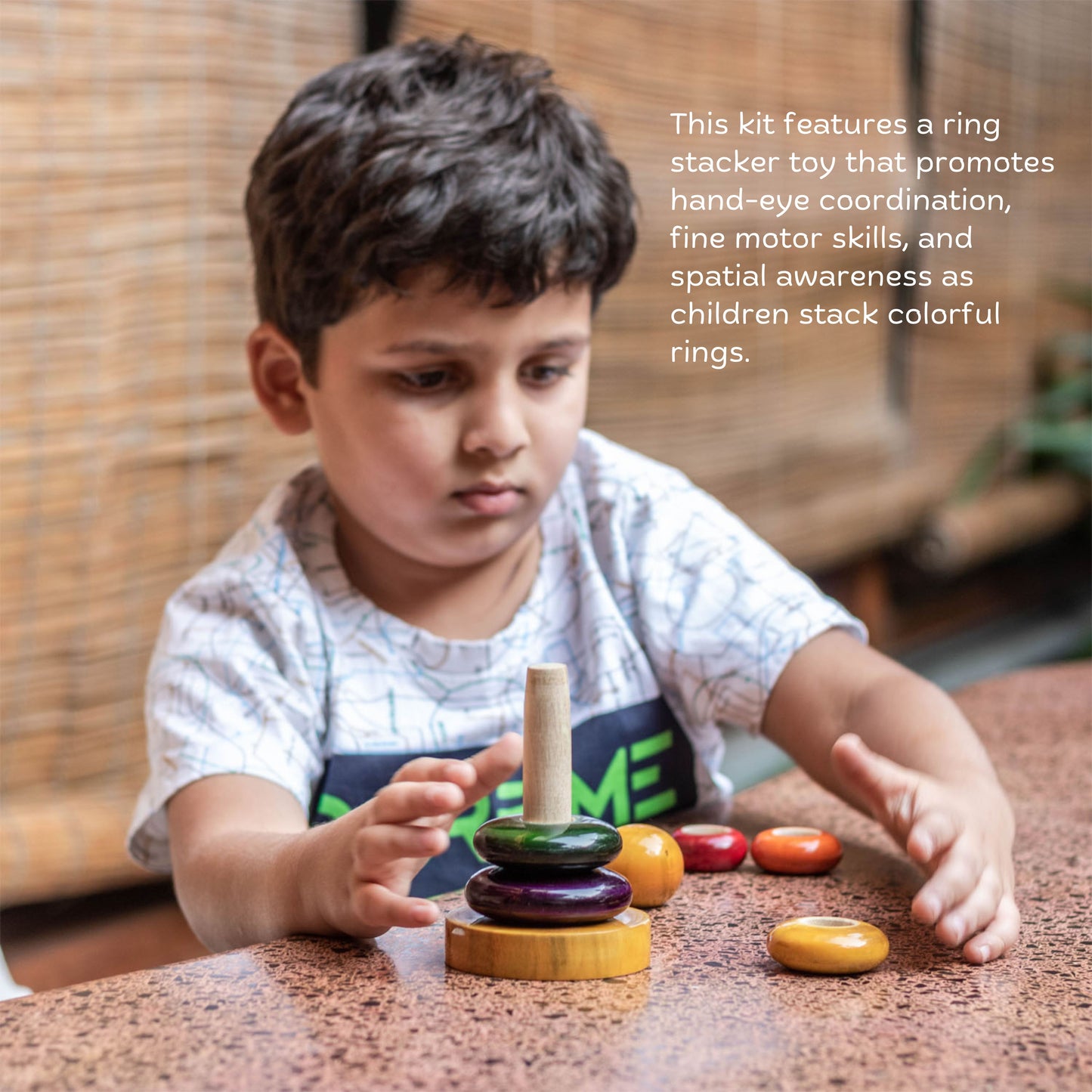 Toddler playing with wooden ring stacker for hand-eye coordination and fine motor skills.
