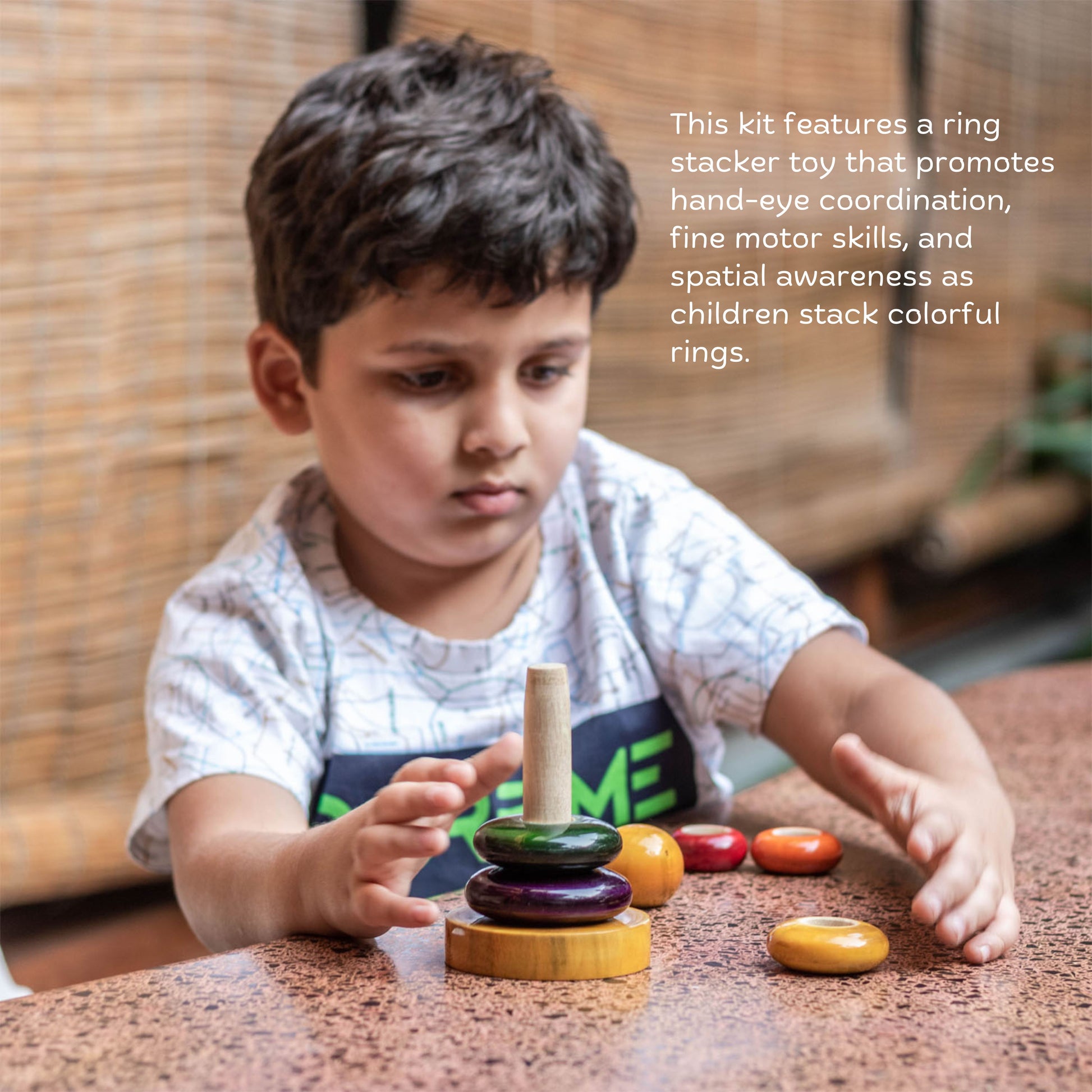 Toddler playing with wooden ring stacker for hand-eye coordination and fine motor skills.