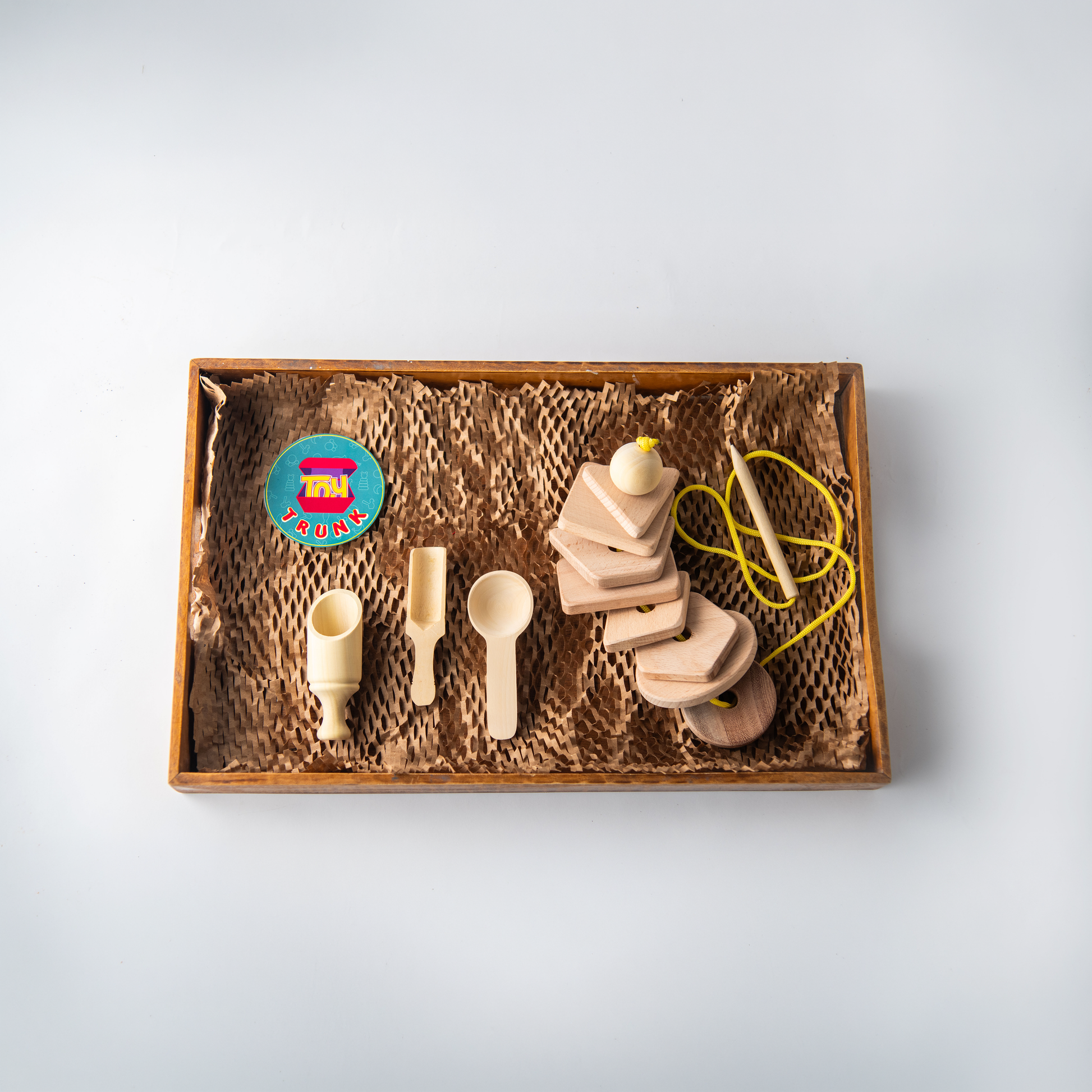 Wooden Mini Montessori Starter Box with threading shapes and spooning toy for toddlers.