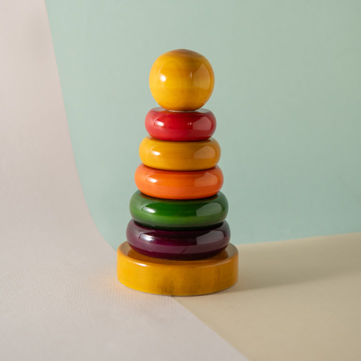 Montessori wooden ring stacker for colour recognition, size sequencing and motor skills.