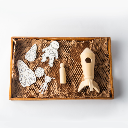 Wooden Space Rocket DIY Toy with astronaut peg doll and paintable backdrop for kids.